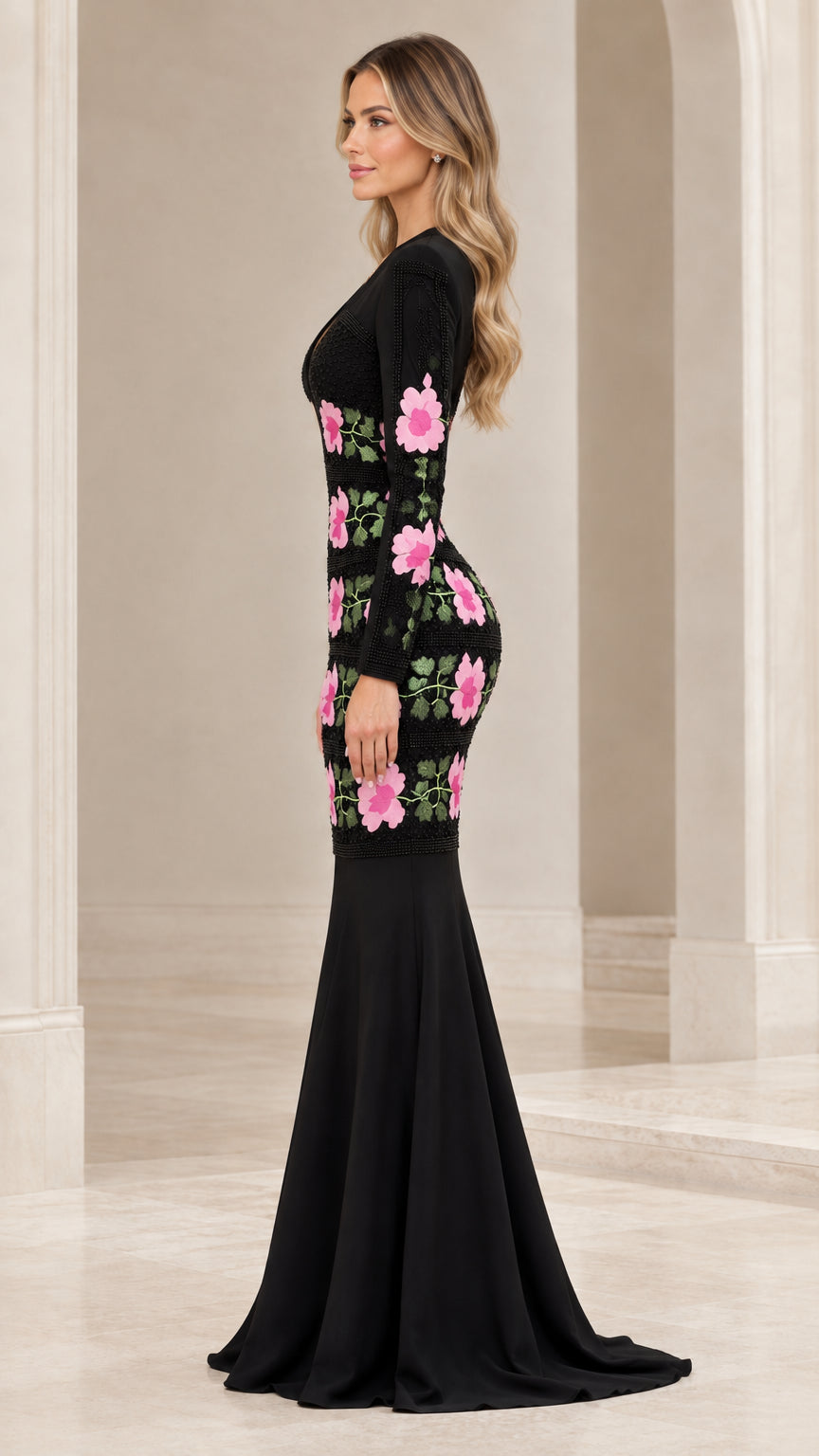 Side profile of black long sleeve mermaid gown showing flared train and hip floral embroidery
