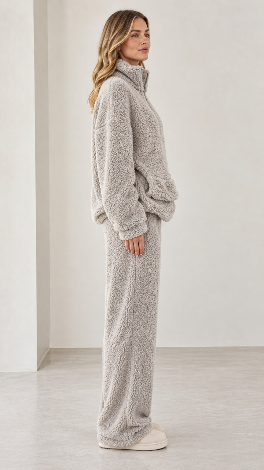 Side profile view of model in light gray teddy fleece matching lounge set