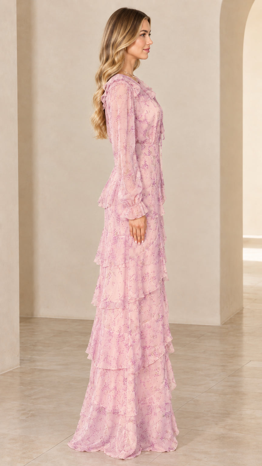 Side view of model showing the flowing silhouette of the blush pink floral maxi dress