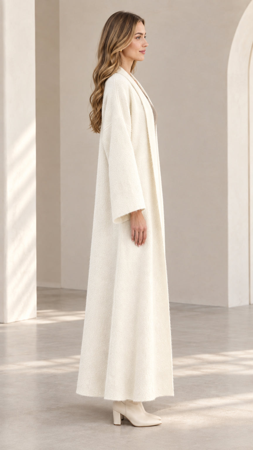 Side profile view of off-white textured longline duster coat