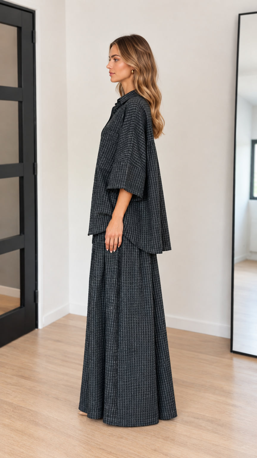 Side profile of model wearing charcoal textured relaxed two-piece set