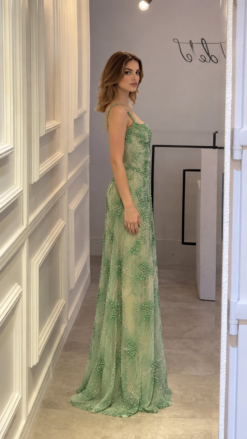 Side profile view of Sage Green beaded floor-length formal gown