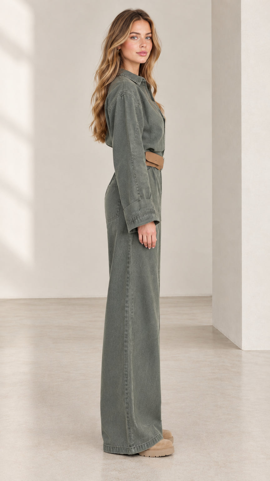 Side view of women's olive green wide leg jumpsuit showing relaxed silhouette