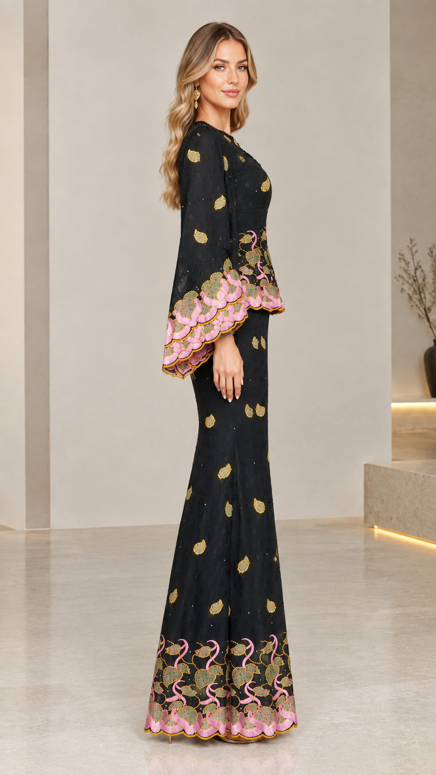 Side profile of woman in black embroidered peplum formal evening gown