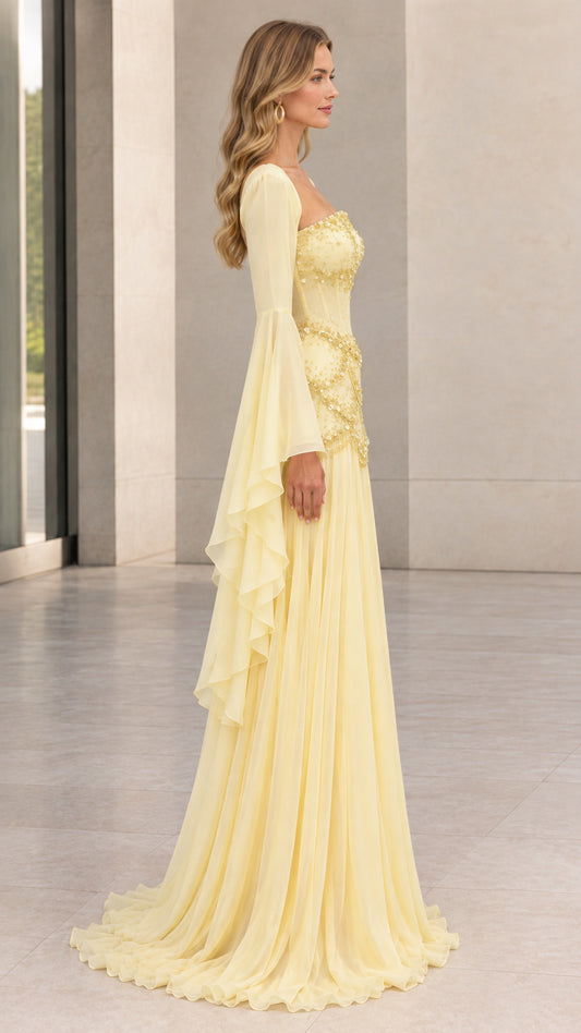 Side view of pastel yellow formal gown showing cascading sleeve drape and floor-length silhouette