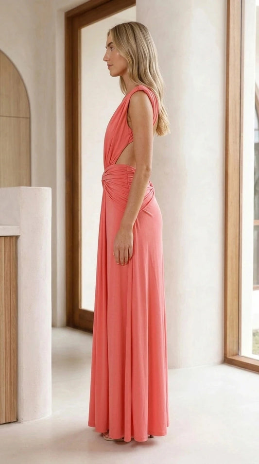 Side view of model showing cutout and drape of coral maxi gown