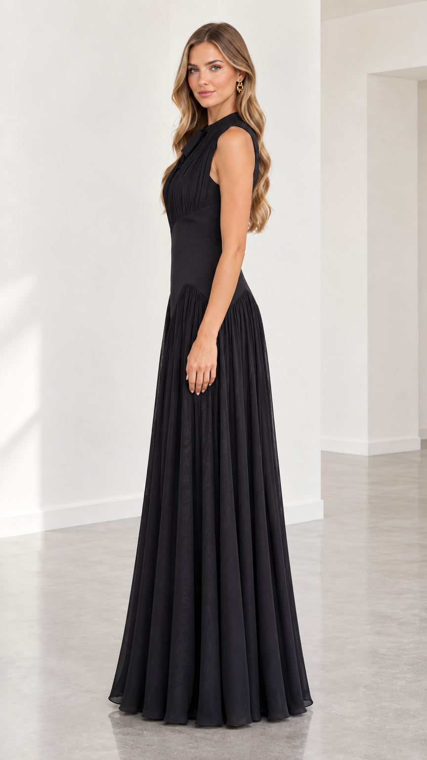 Side profile view of black sleeveless pleated floor-length gown