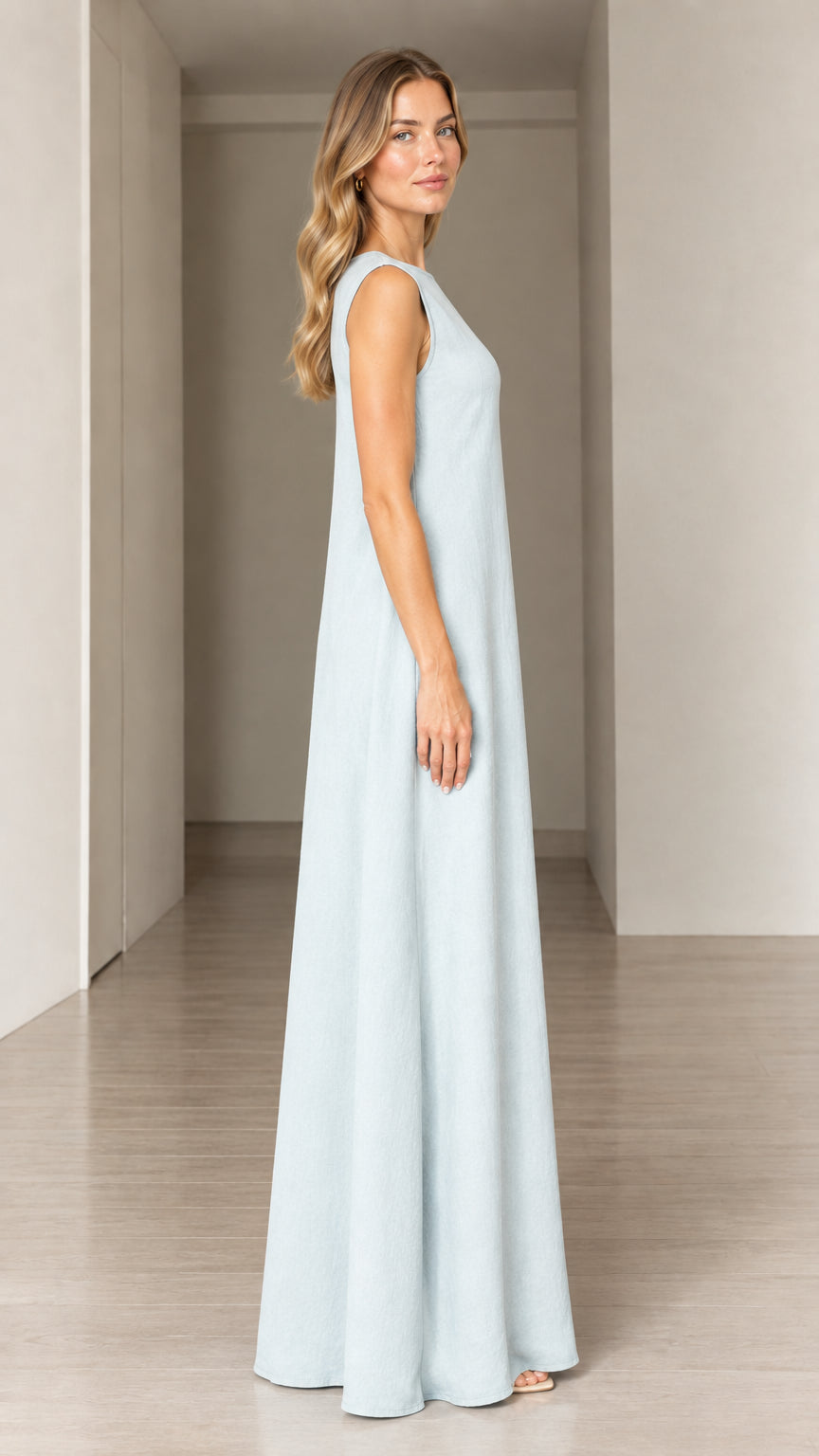 Side profile view of woman wearing Light Blue sleeveless full-length dress