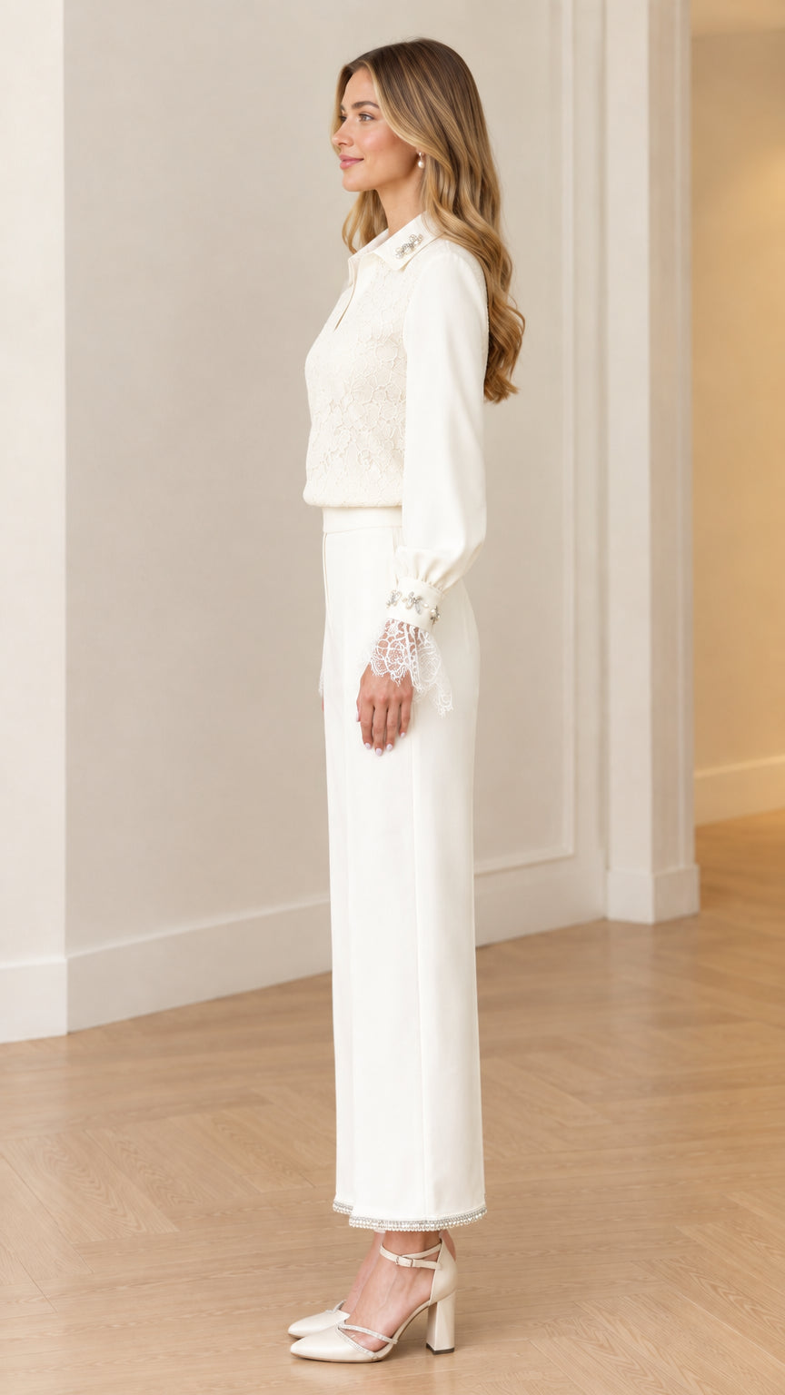 Side profile view of women's white formal lace top and tailored trousers