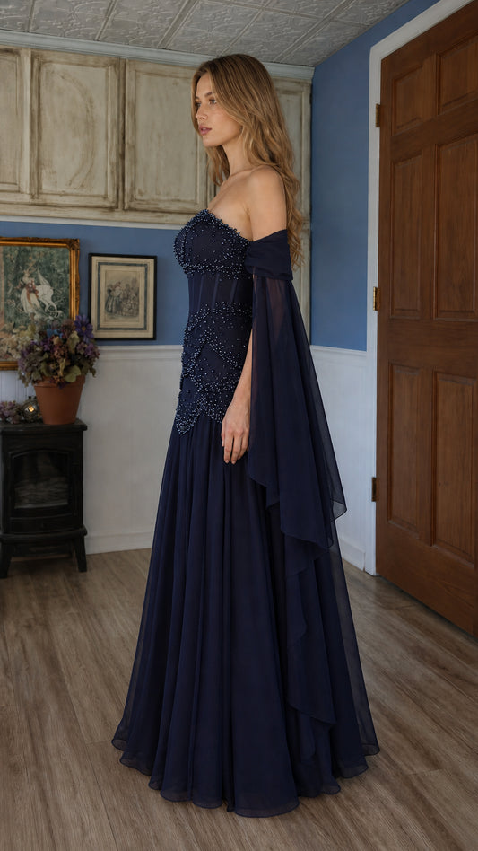 Side profile of navy blue evening gown with draped sleeves