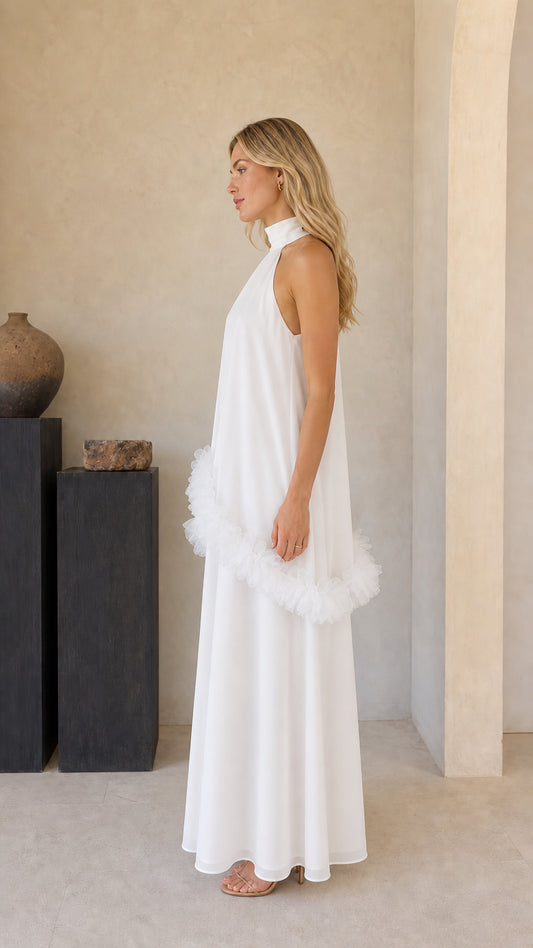 Side profile of model in white sleeveless tiered ruffle maxi gown