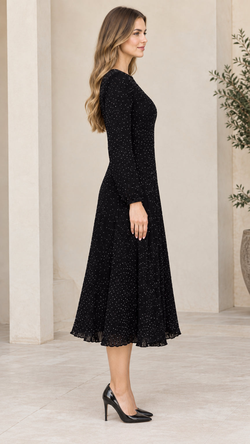 Side profile of woman wearing black long sleeve micro dot midi dress