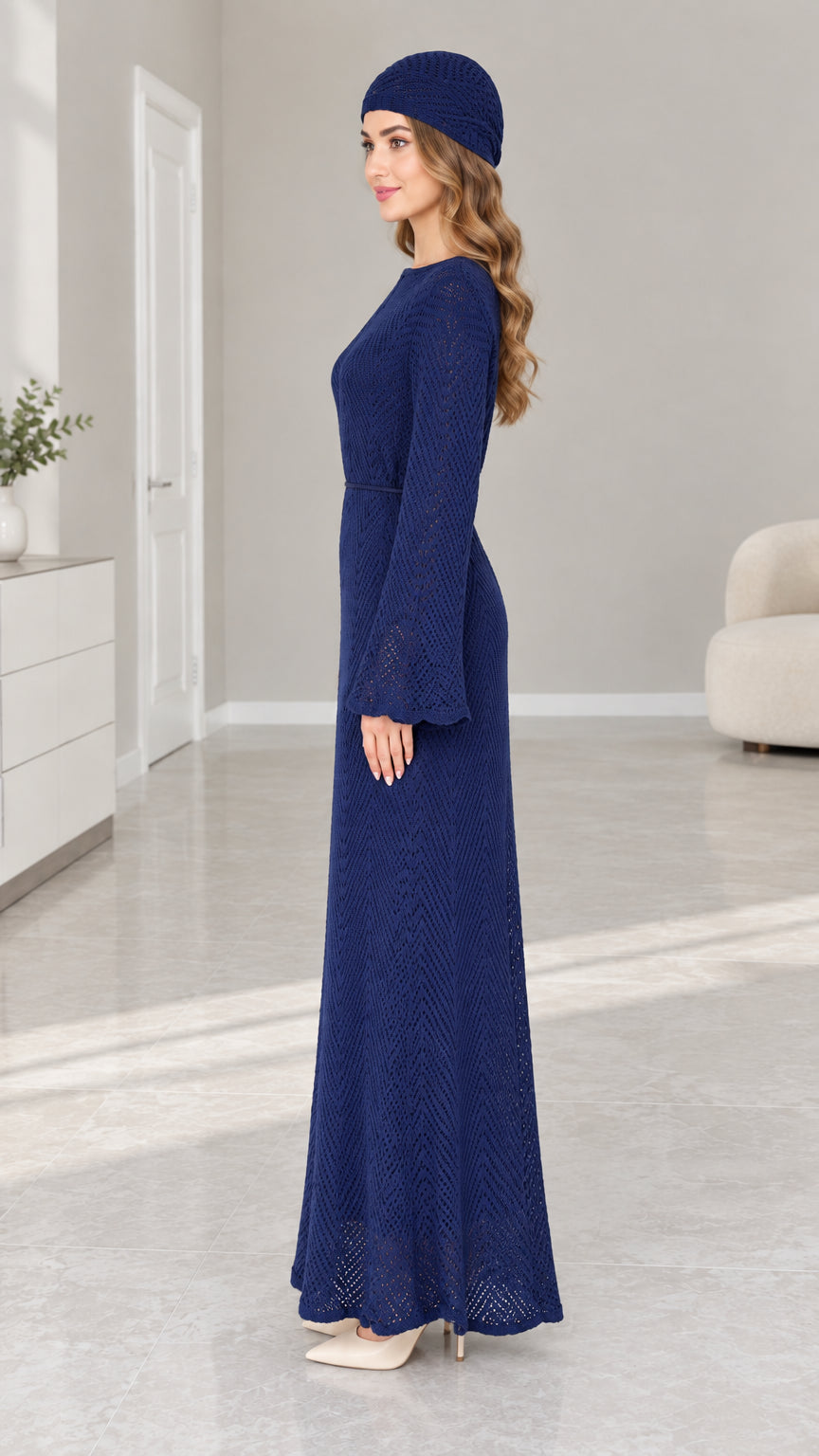 Side profile view of woman in Navy Blue textured long sleeve knit maxi dress