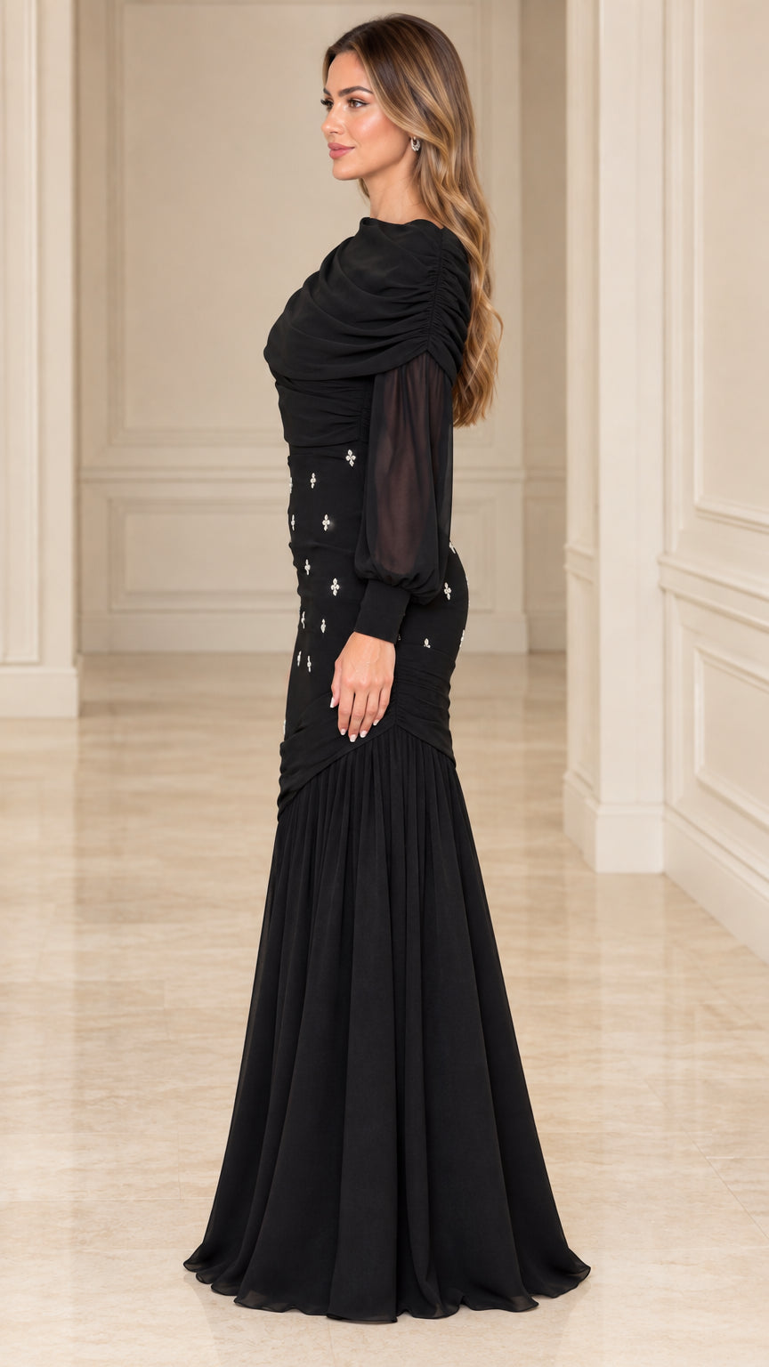 Side profile view of model wearing black long sleeve formal evening gown