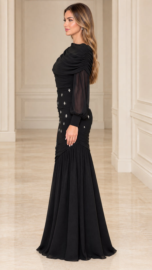 Side profile view of model wearing black long sleeve formal evening gown