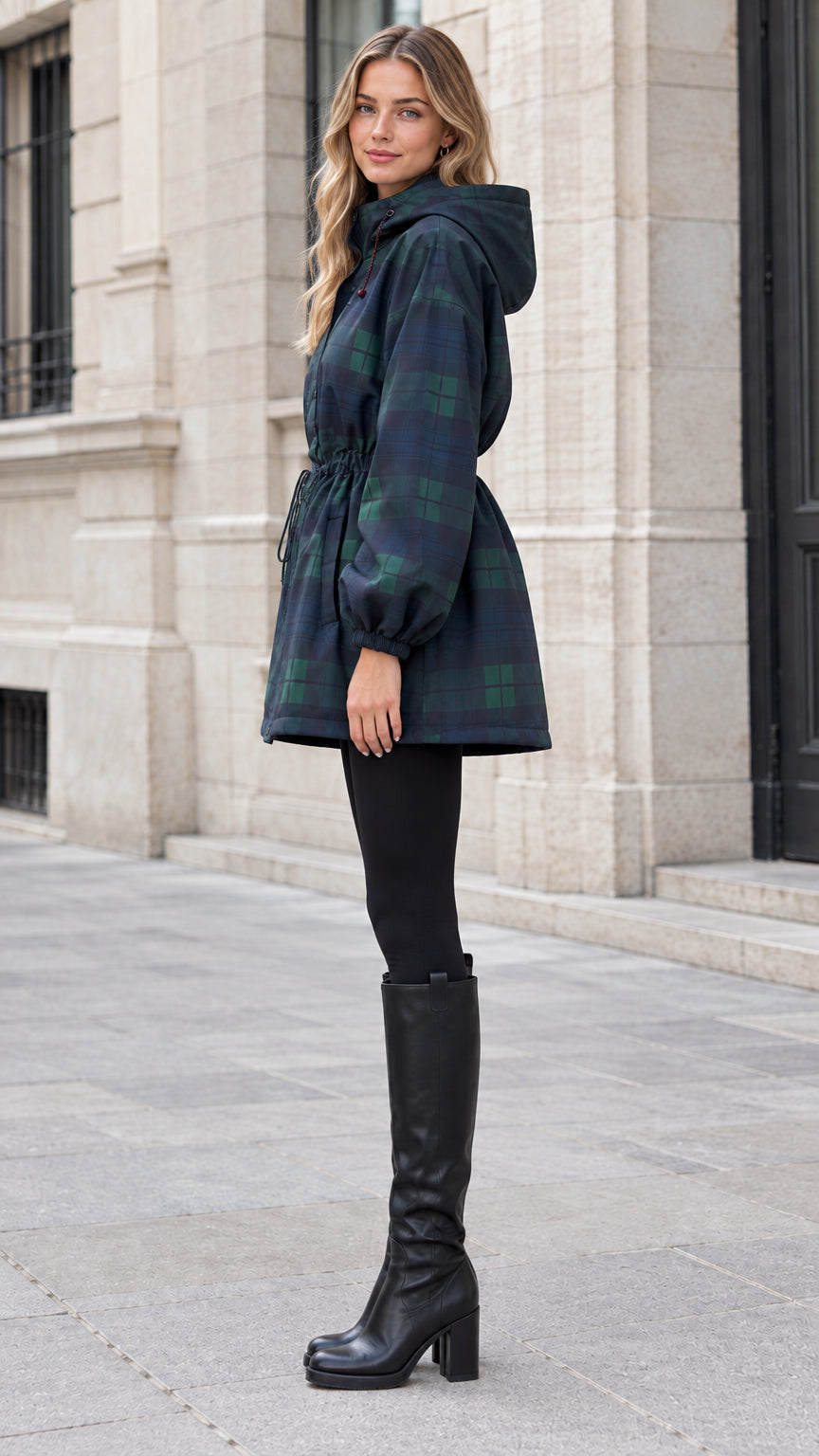 Side angle view of navy green plaid hooded jacket showing cinched waist and knee-high boots
