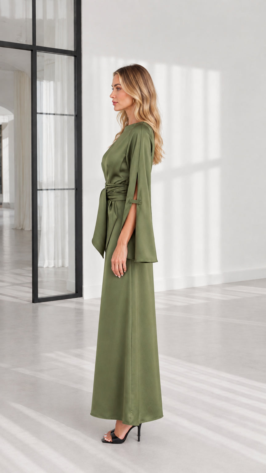 Side profile of woman wearing olive green long sleeve evening maxi dress