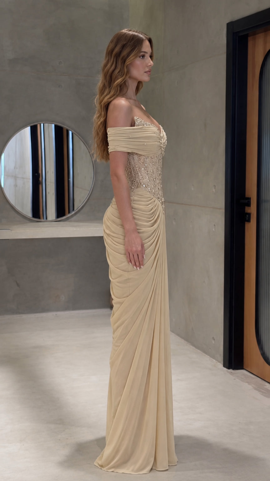 Side profile view of champagne draped corset evening dress