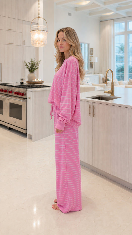 Side profile view of model wearing pink striped two-piece loungewear set