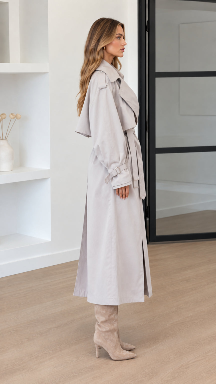 Side profile of woman wearing Light Grey long belted trench coat