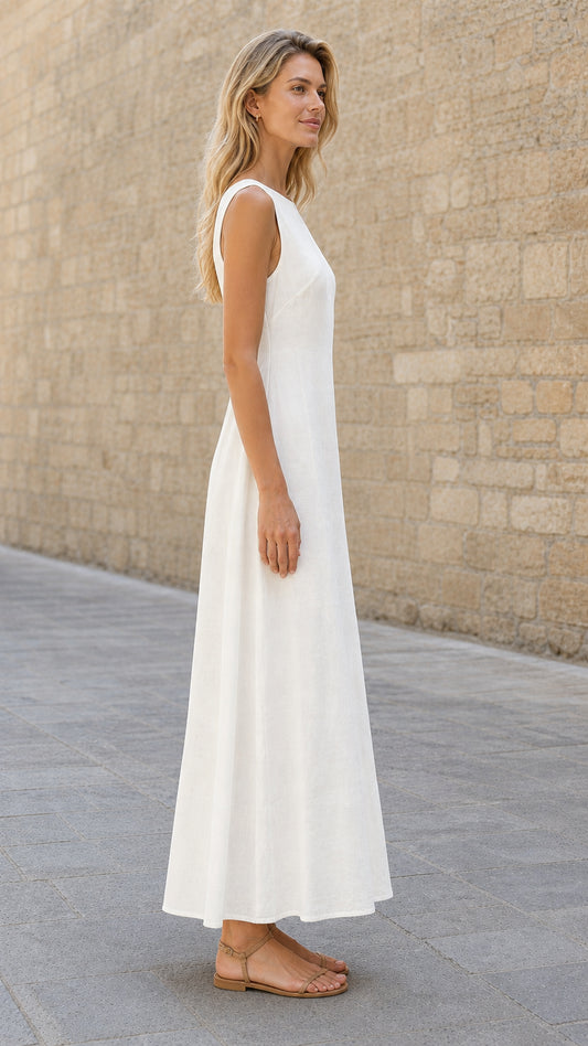 Side profile view of woman in white maxi dress