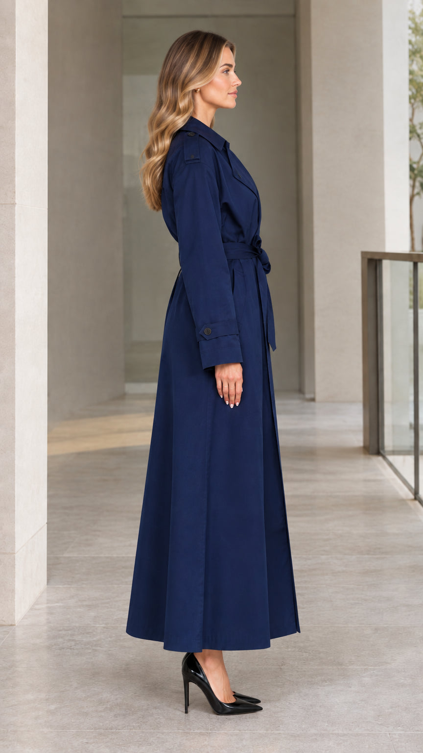 Side profile view of model wearing Navy Blue maxi trench coat with tie belt