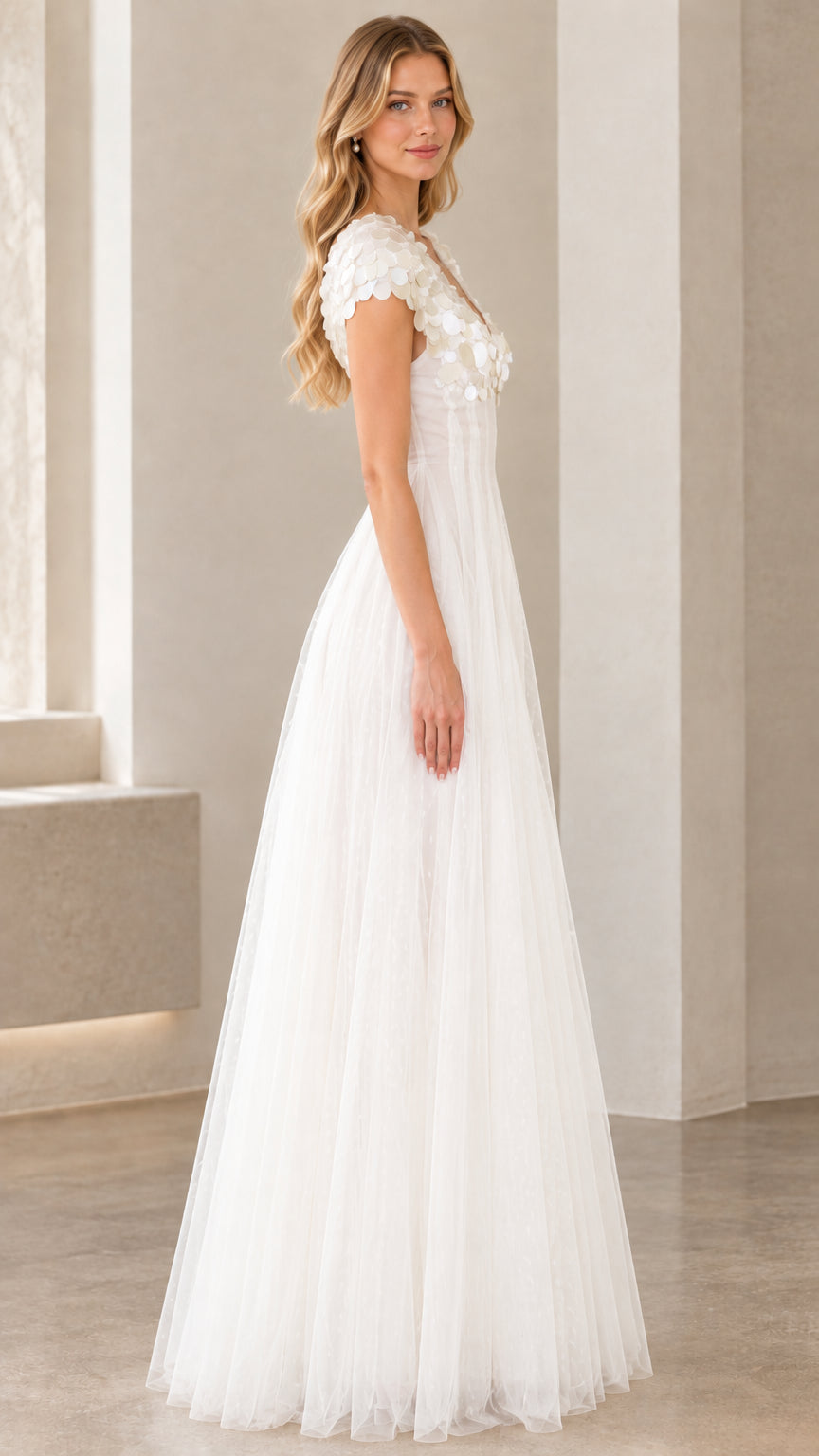 Side profile view of white tulle A-line maxi formal gown