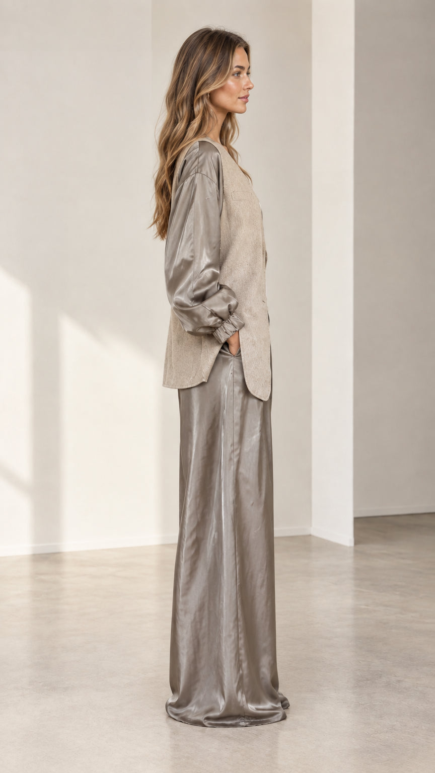 Side angle view of taupe two-piece satin and textured blazer pant set