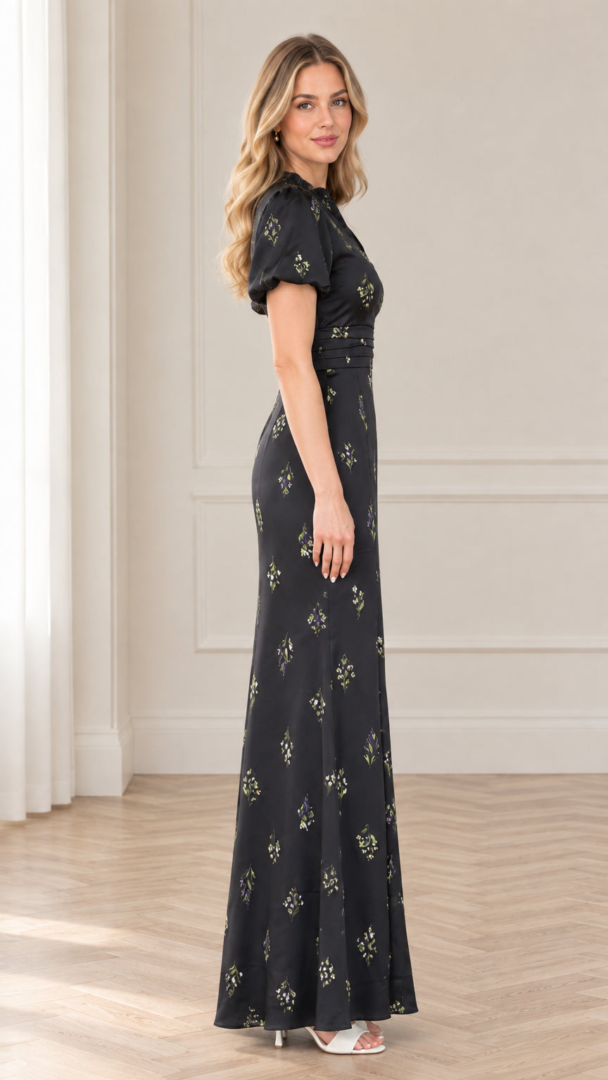 Side profile view of black floral print floor-length evening dress