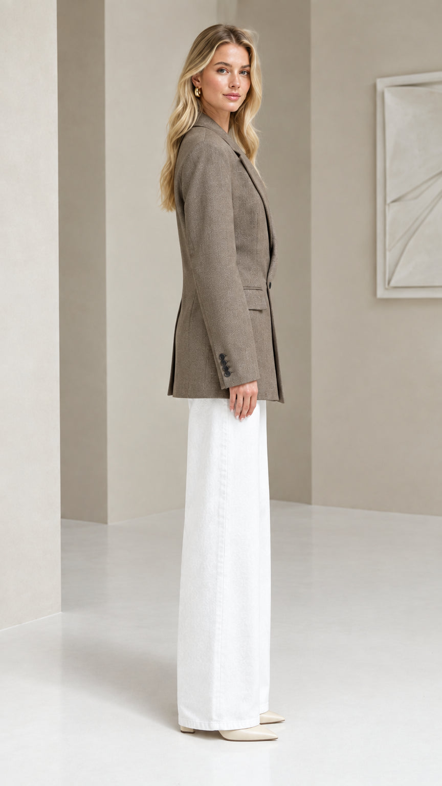 Side profile of taupe tailored blazer showing clean structured silhouette