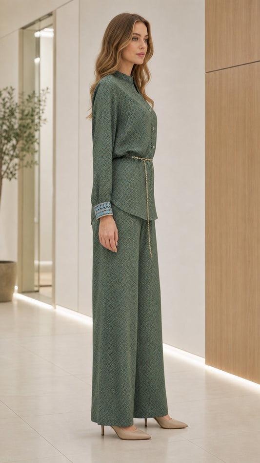 Side profile of model in sage green matching blouse and wide-leg pants