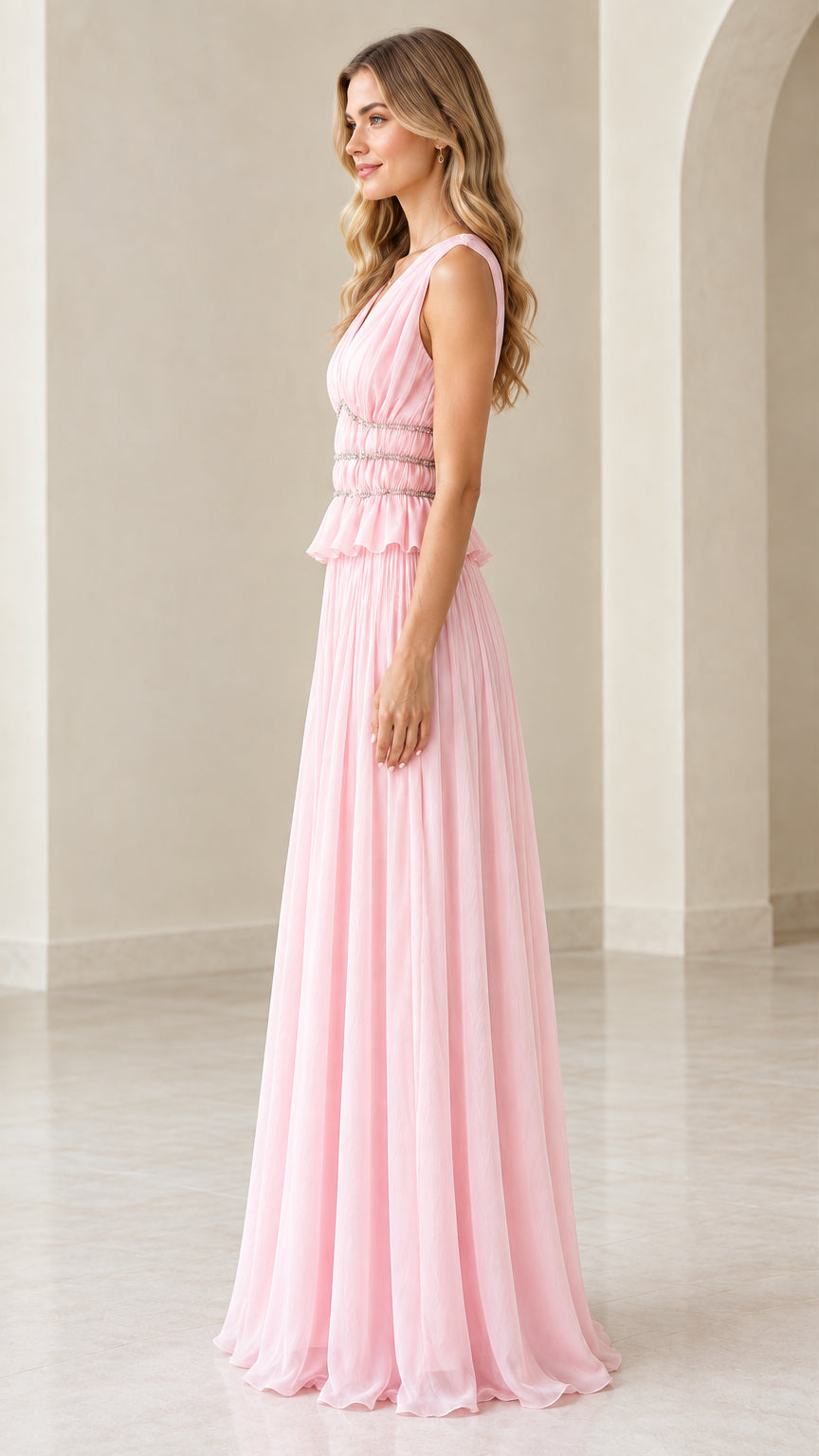 Side profile view of pink floor-length pleated evening gown
