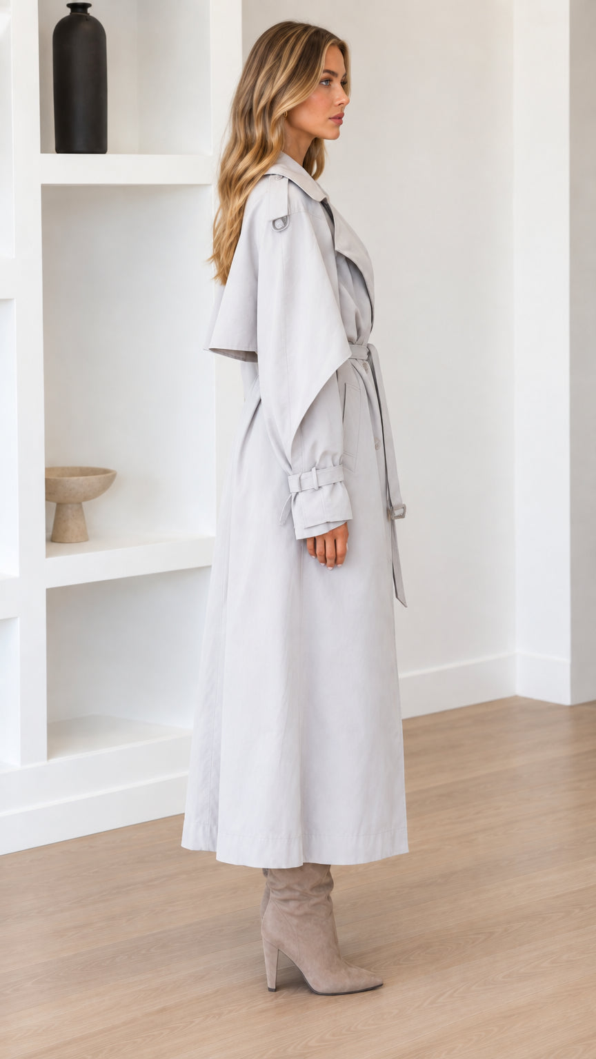 Side profile of woman in Light Grey longline trench coat with cape detail