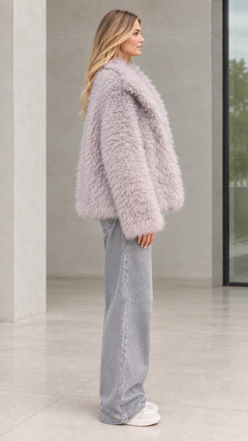 Side profile of model in dusty lilac shaggy plush coat showing relaxed silhouette