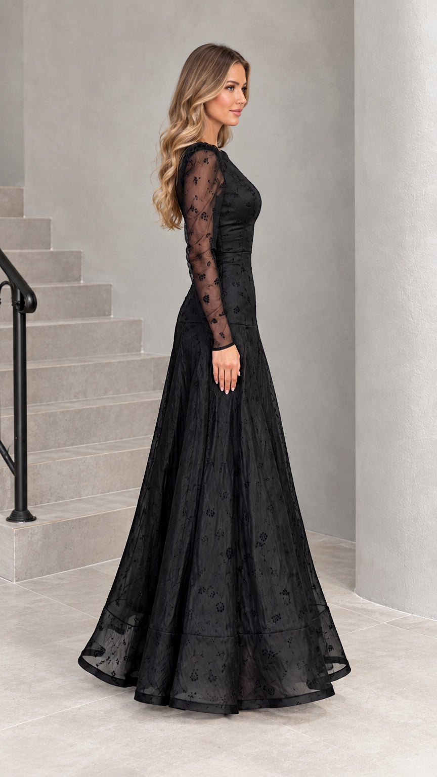 Side profile view of black embroidered formal dress with sheer sleeves