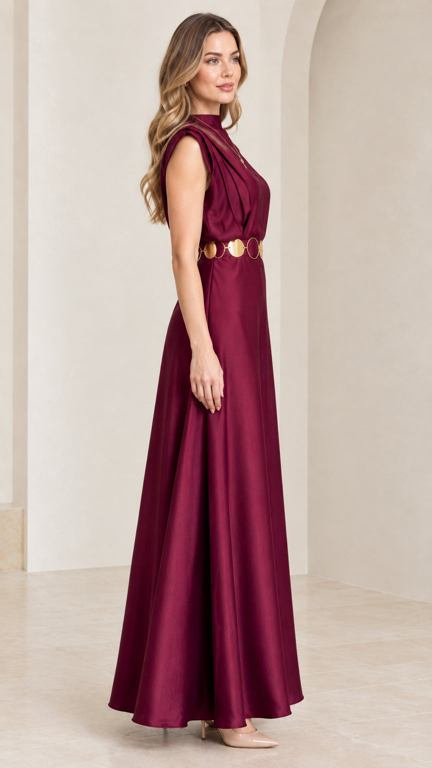 Side profile of model in burgundy pleated satin maxi dress