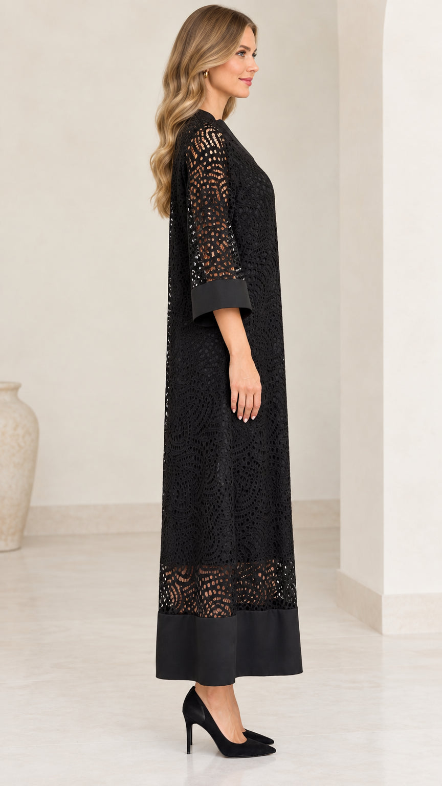 Side profile of model wearing black 3/4 sleeve lace maxi dress