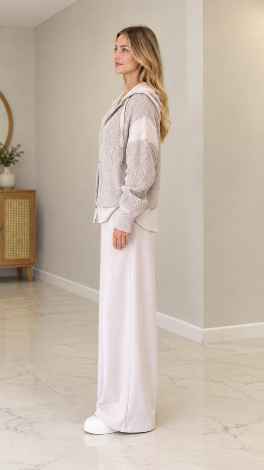 Side profile view of model wearing Oatmeal cable-knit hooded cardigan jacket