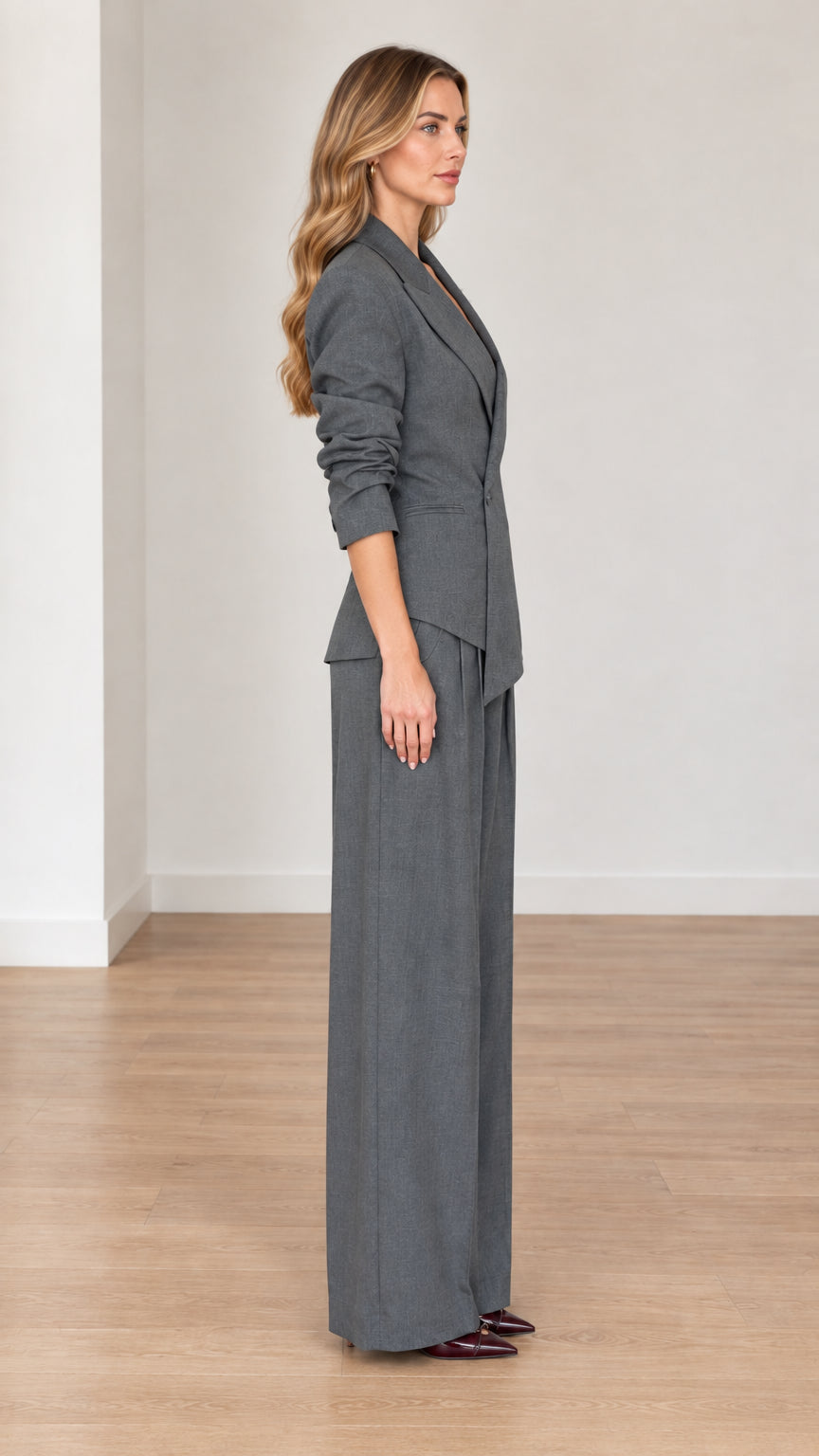Side profile view of woman modeling Charcoal Grey tailored pant suit set