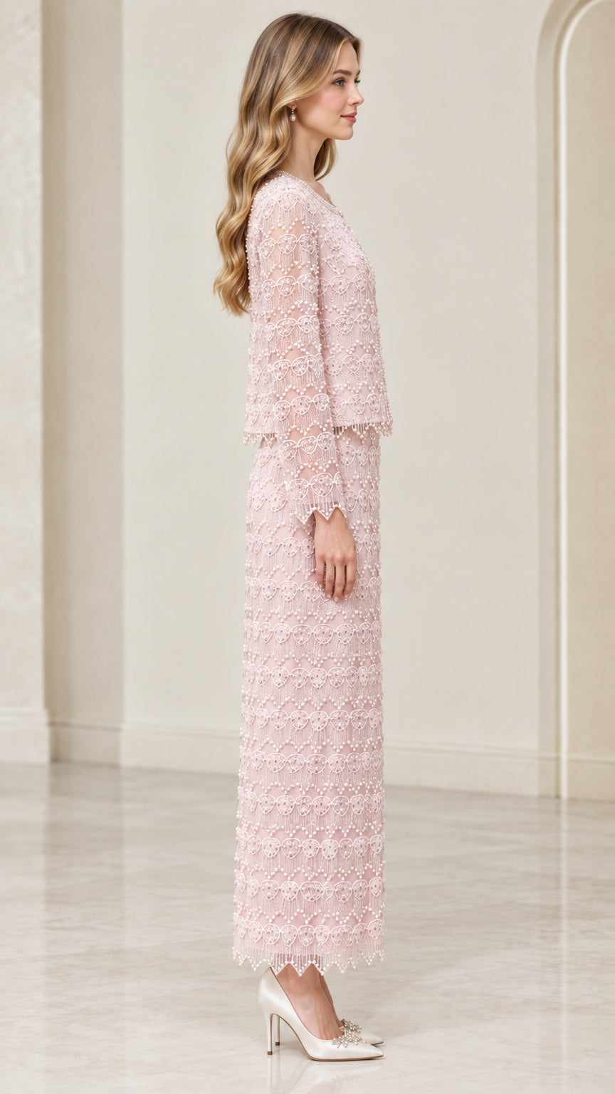 Side profile view of woman wearing blush pink beaded jacket and maxi column skirt