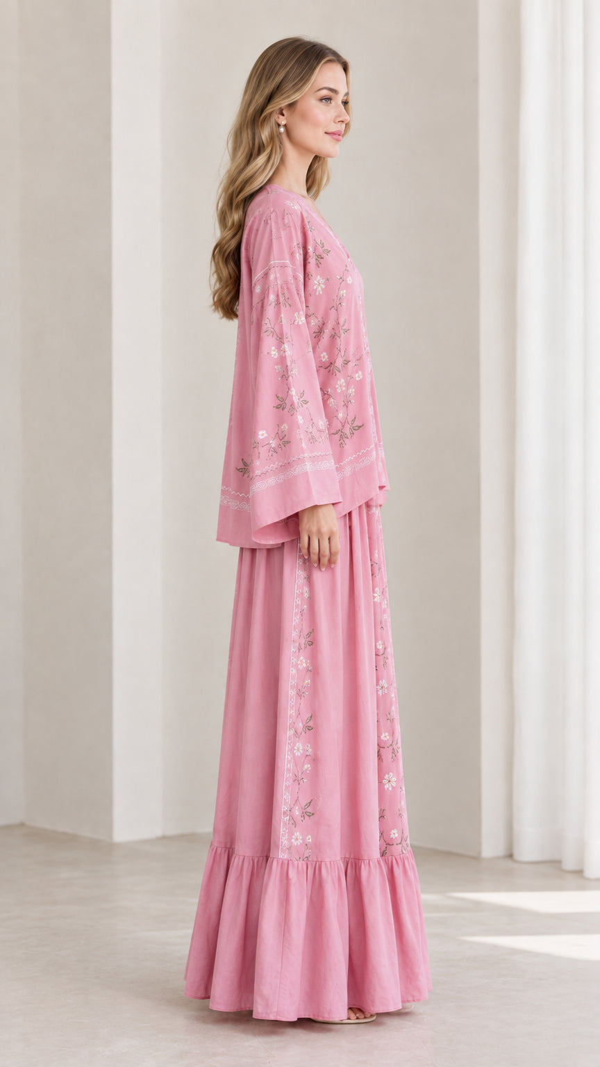 Side profile view of model wearing pink two-piece embroidered skirt set