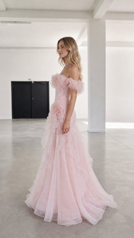 Side profile view of pink tulle evening gown with cascading ruffles