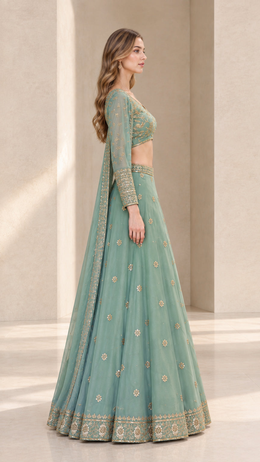 Side profile view of woman wearing sage green long sleeve lehenga choli set