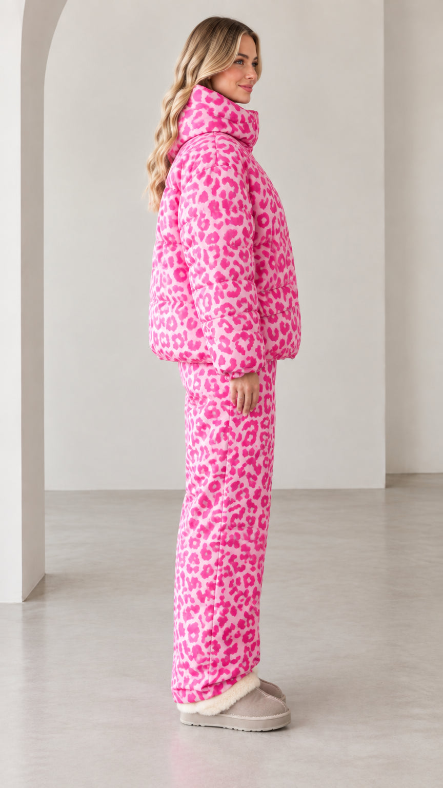 Side profile view of model in pink leopard print insulated puffer tracksuit