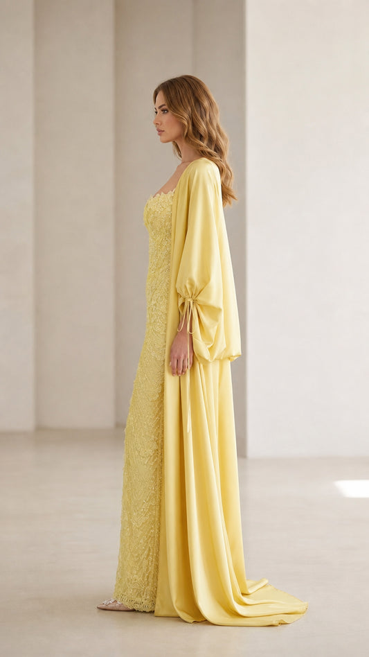 Side profile view of yellow evening gown and draped cape