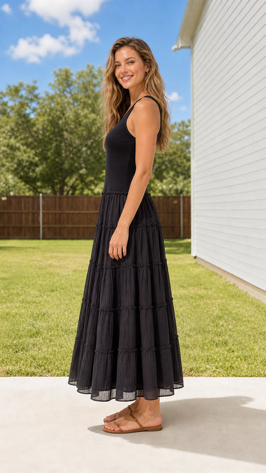Side 3/4 view of woman wearing Black tiered ribbed tank maxi dress