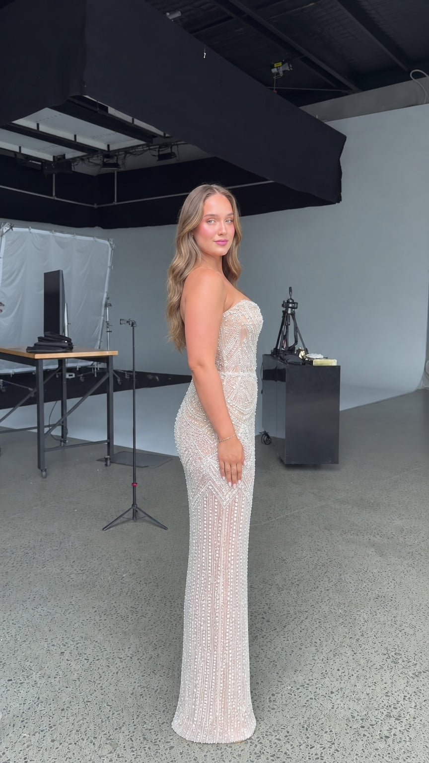Side profile view of model wearing champagne embellished maxi dress