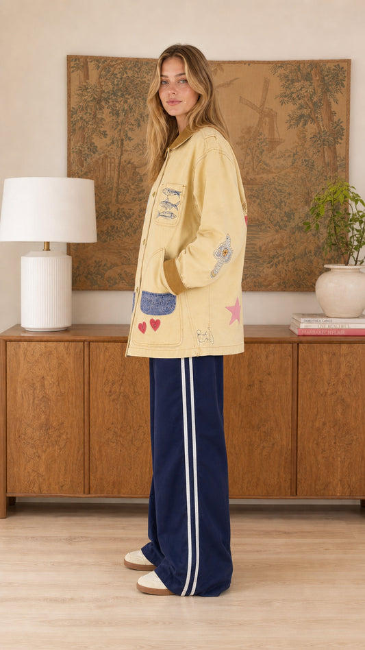 Side profile of model wearing the oversized butter yellow coastal utility jacket