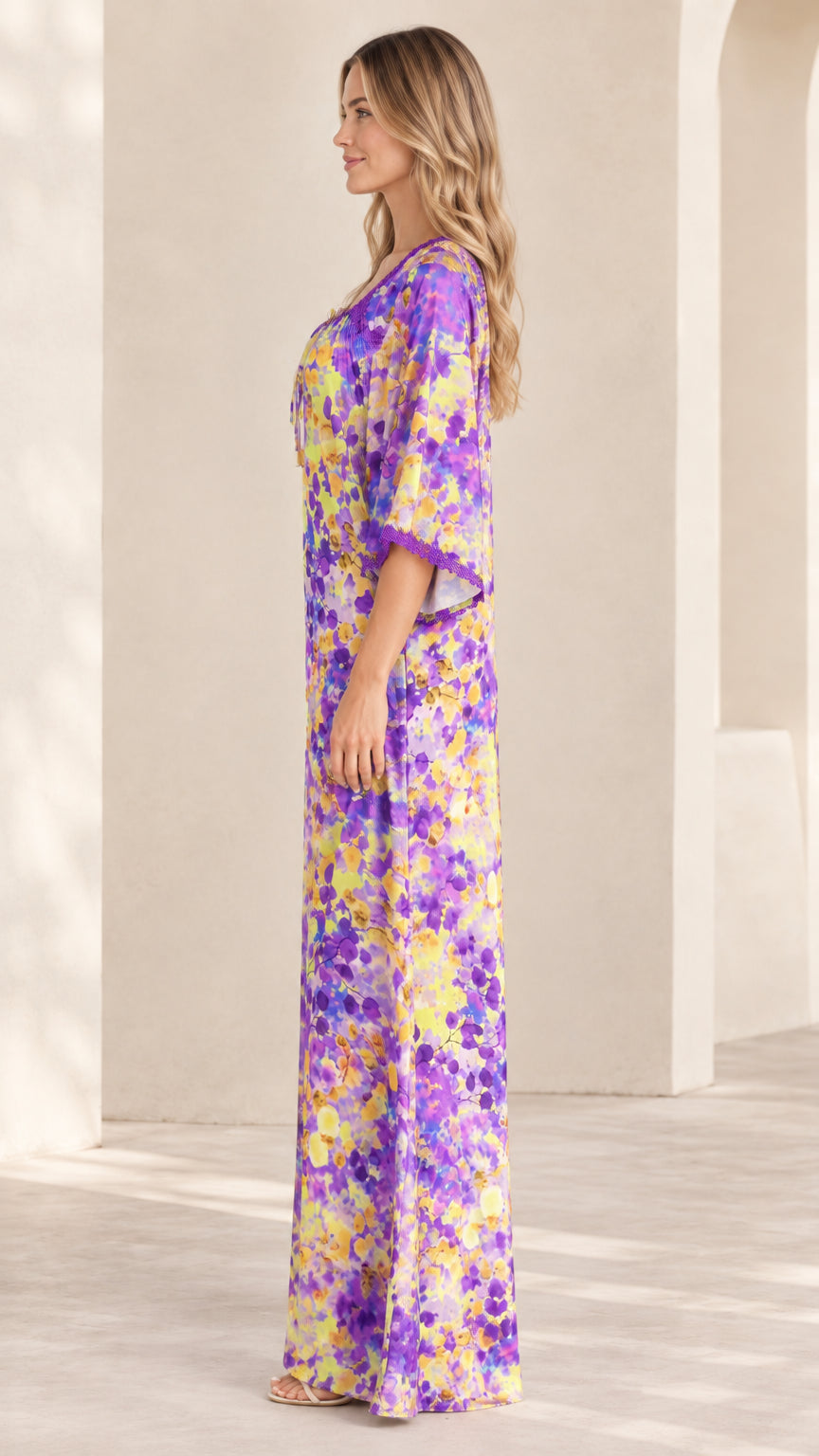 Side profile view of purple floral print kaftan maxi dress showing flowing relaxed drape