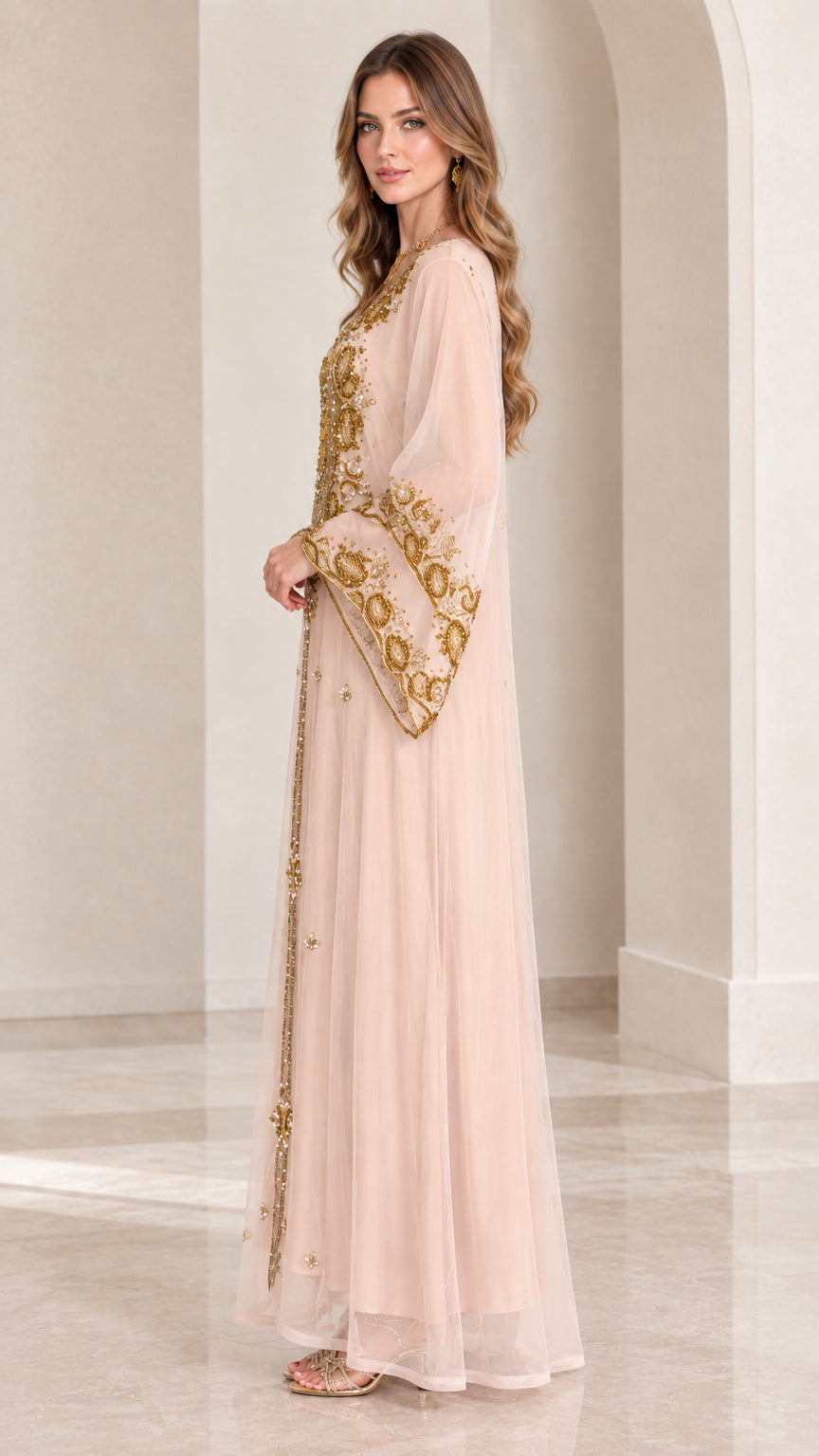 Side profile of woman in blush pink embellished long sleeve kaftan abaya